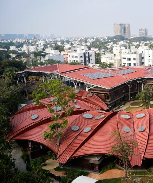 layered red roof sweeps over vastushilpa sangath’s verdant school in chennai, india
